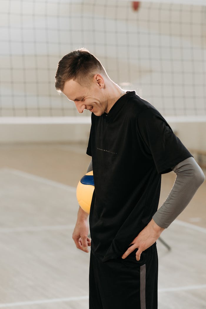 Man in Black Shirt Standing while Looking Down